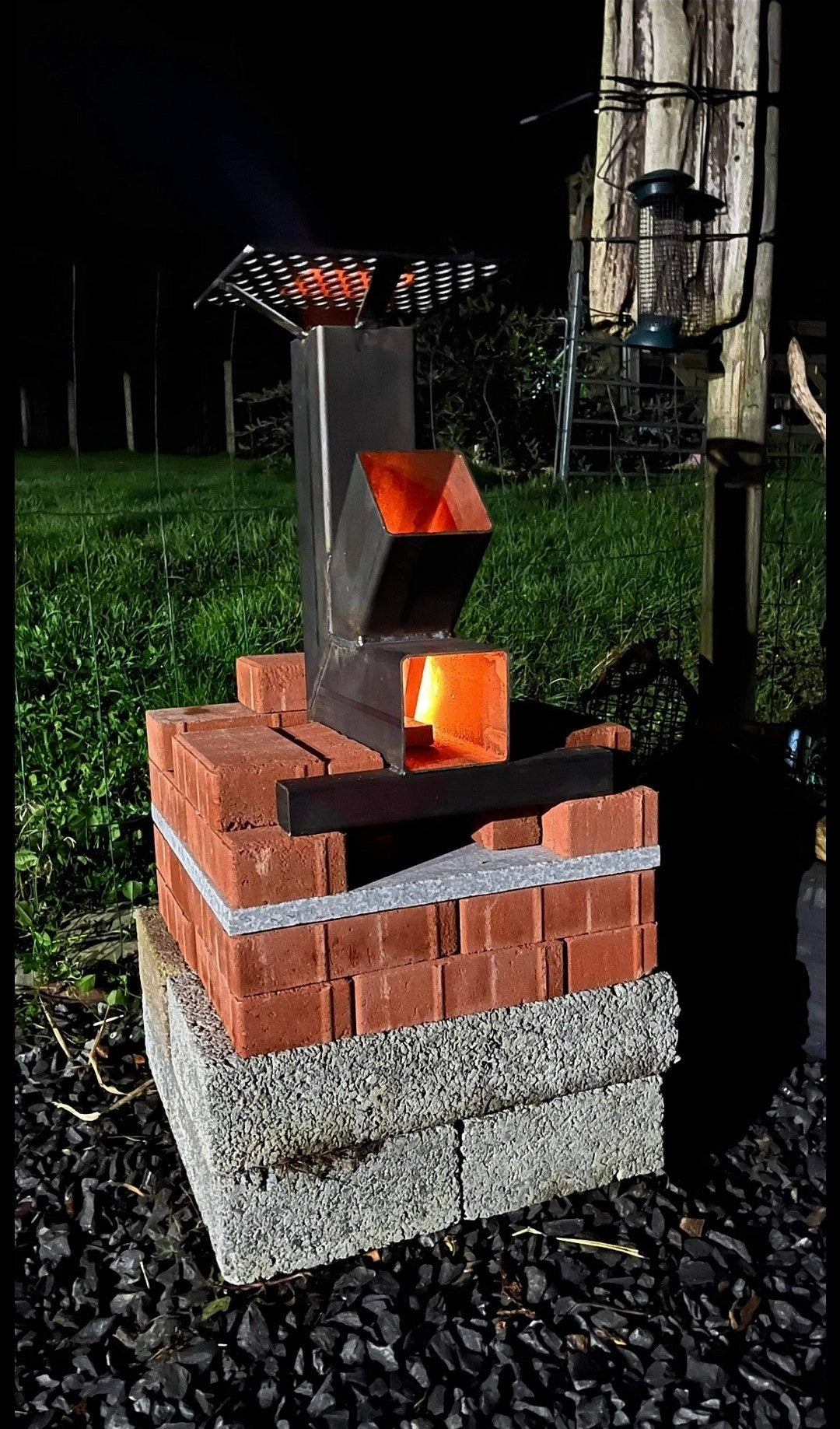 rocket stove set up on bricks by Fire Pit Stop NI